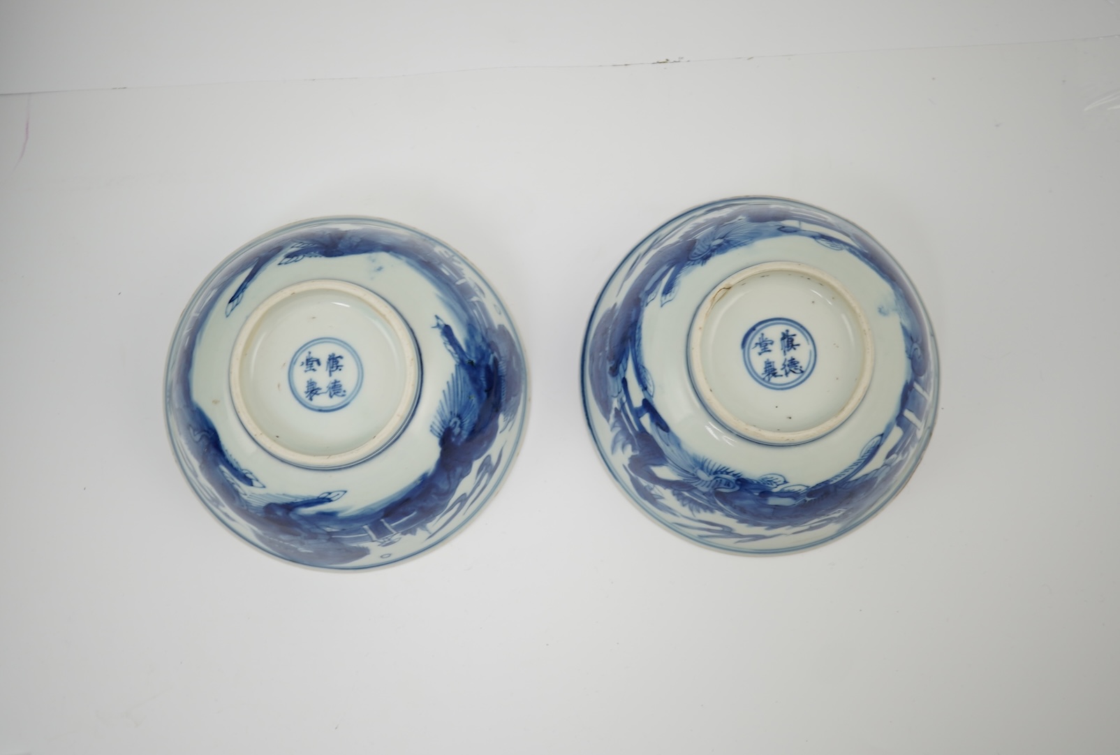 A pair of Chinese Transitional blue and white 'mythical beasts' bowls, early Kangxi period